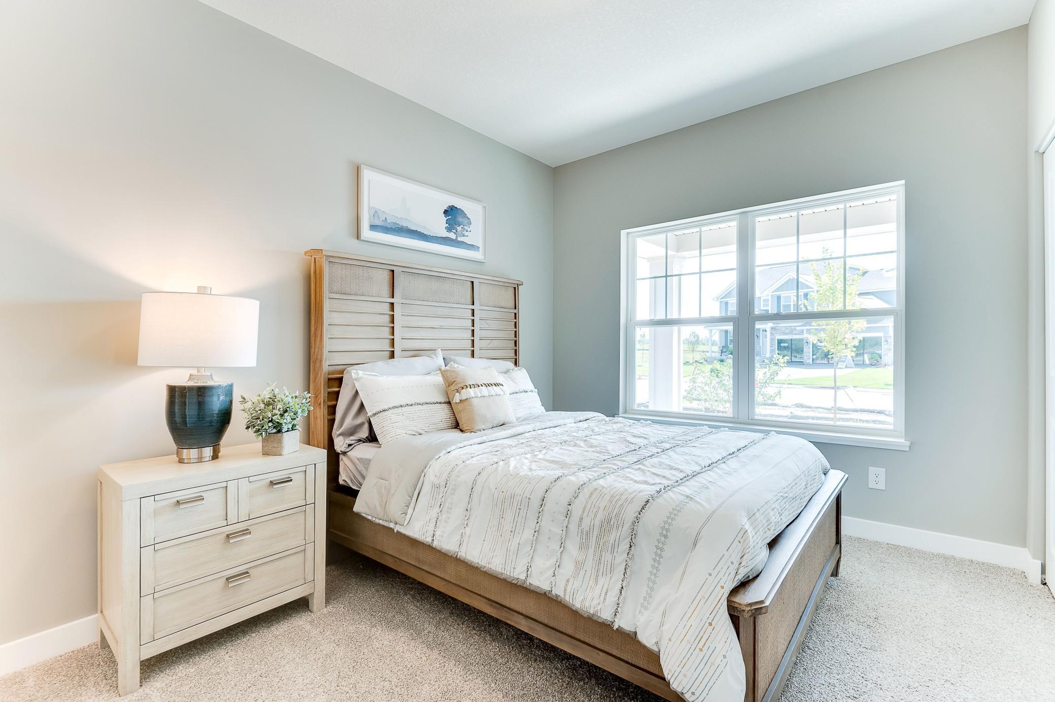 Highly sought after on the main level, this bedroom offers the a room for overnight guest. Complete with a private full bath, it is just a perfect addition to the floor plan! Photo of model home, color and options will vary.