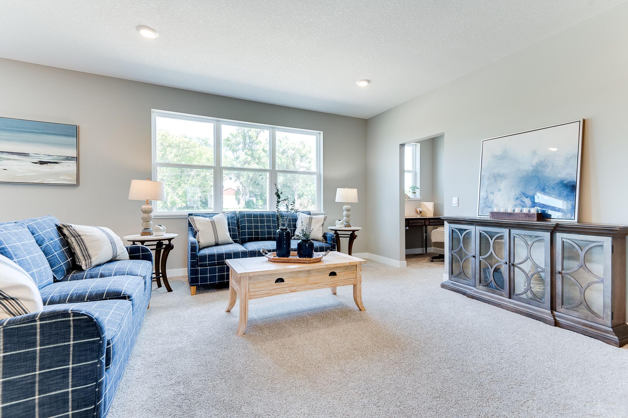 Soaring windows flood your main level family room in natural light - overlooking a sodded generous size backyard & enlightening a space large enough to accommodate just about any furniture combination! Photo of model home, color & options will vary.
