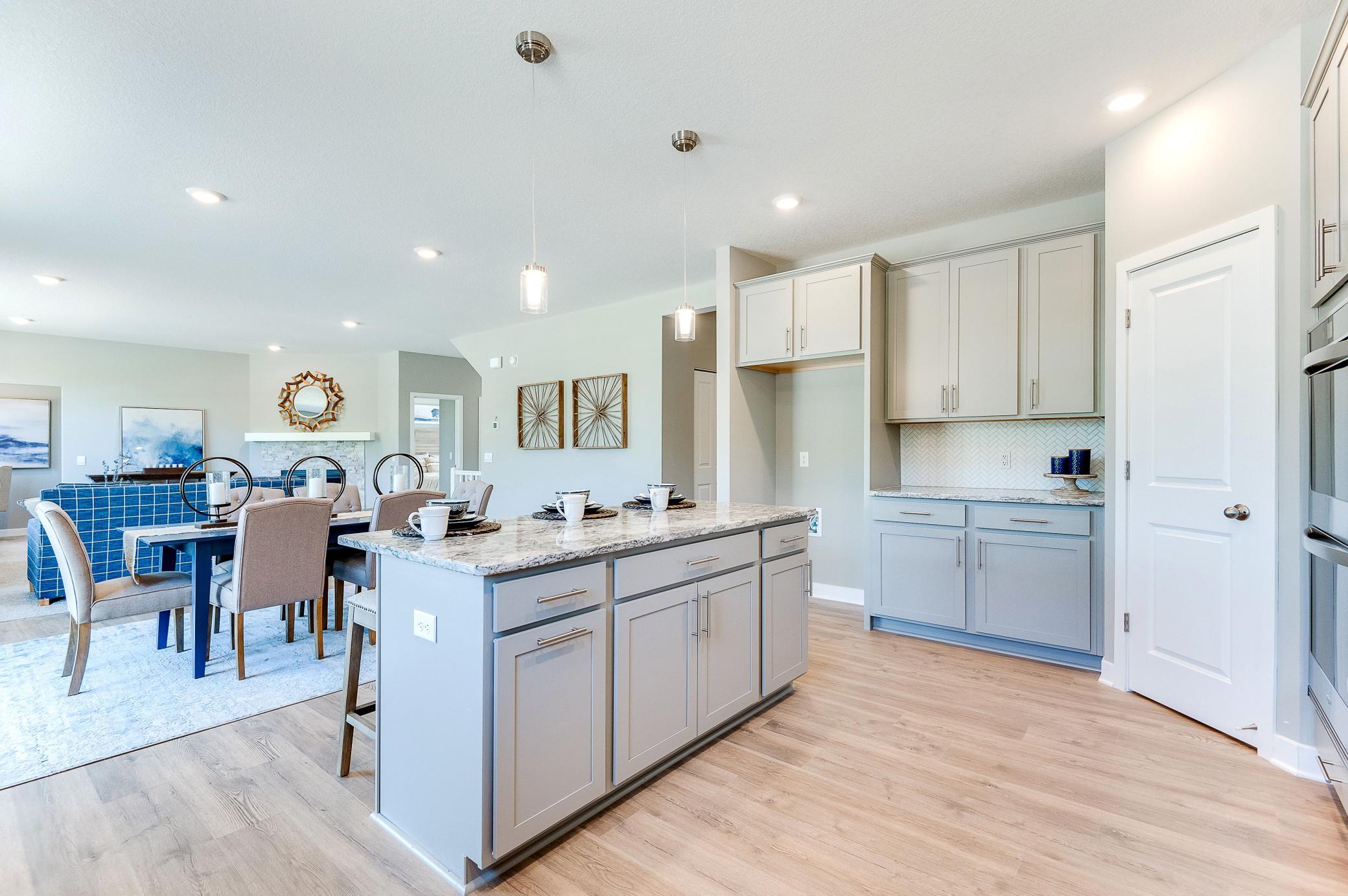 The function extends to the other side of the kitchen space as well, where a six-foot deep walk-in pantry resides. Photo of model home, color and options will vary.
