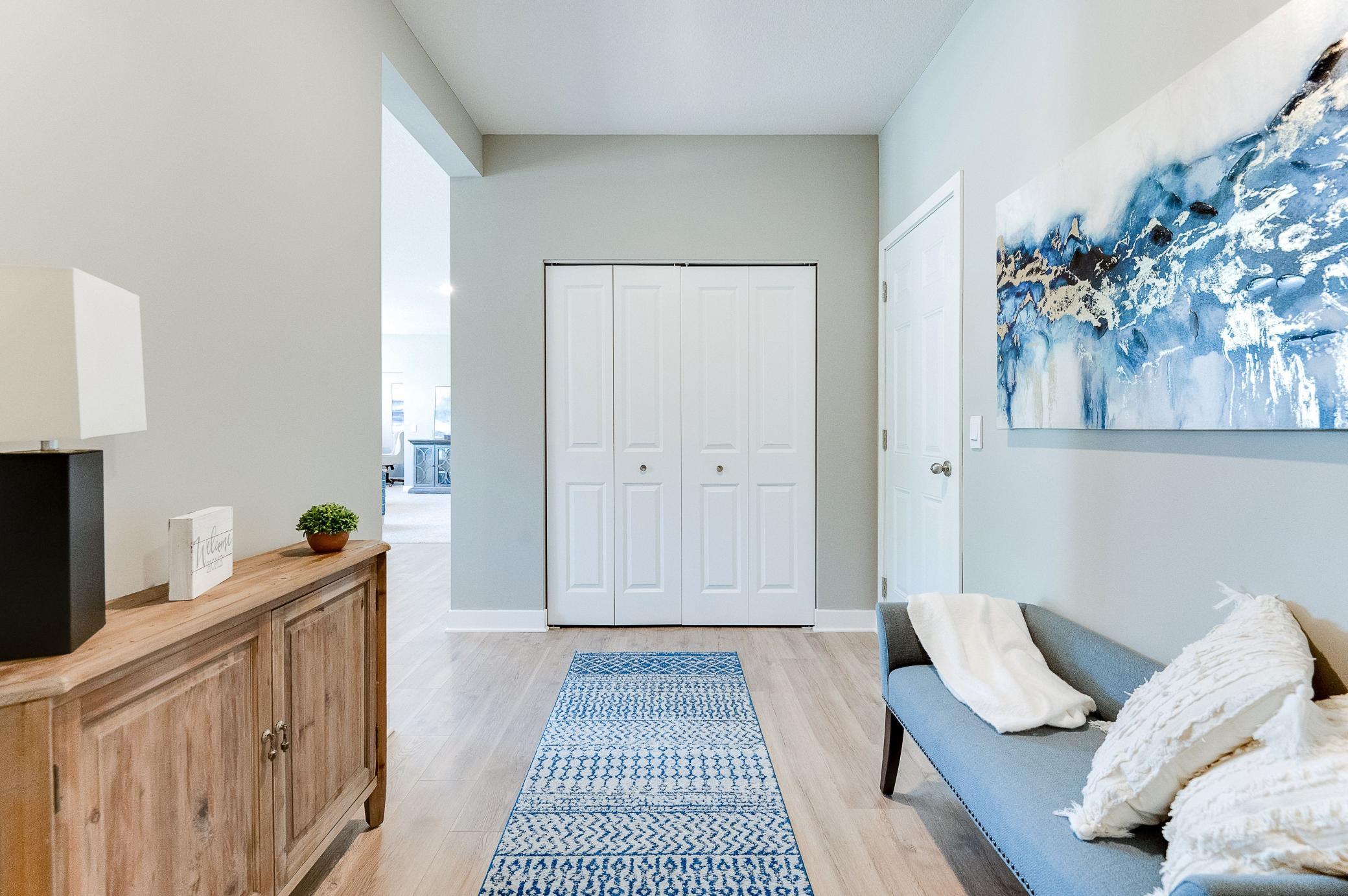 Another view of the mudroom space, which (like the rest of the main level) is wide open and features both a large coat closet and powder room bath! Photo of model home, color and options will vary.