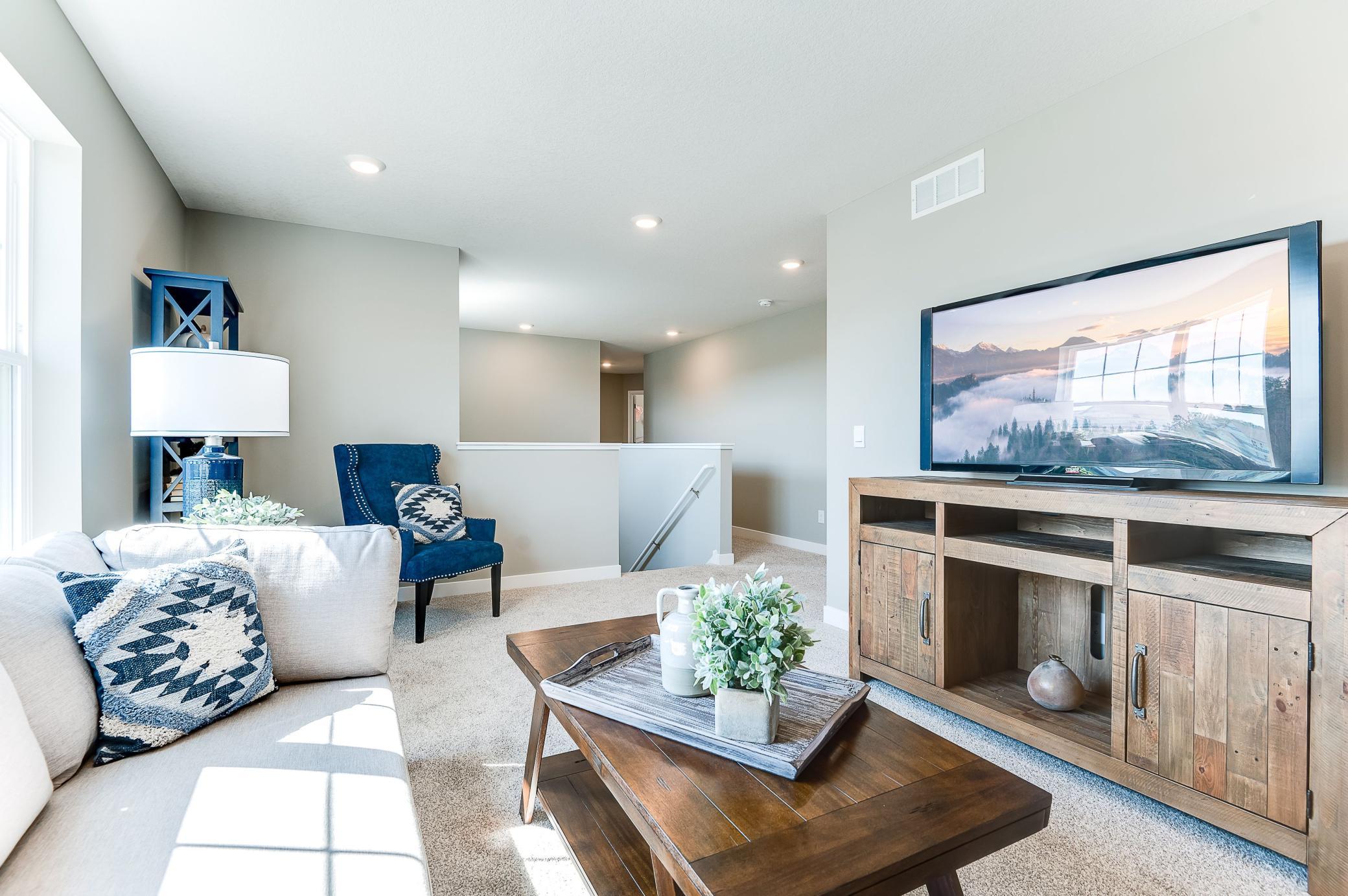The entire level flows from the focal point offered by this huge loft space. Sure to become a family favorite hangout spot, the room is just steps from each of the home's three upper level bedrooms! Photo of model home, color & options will vary.