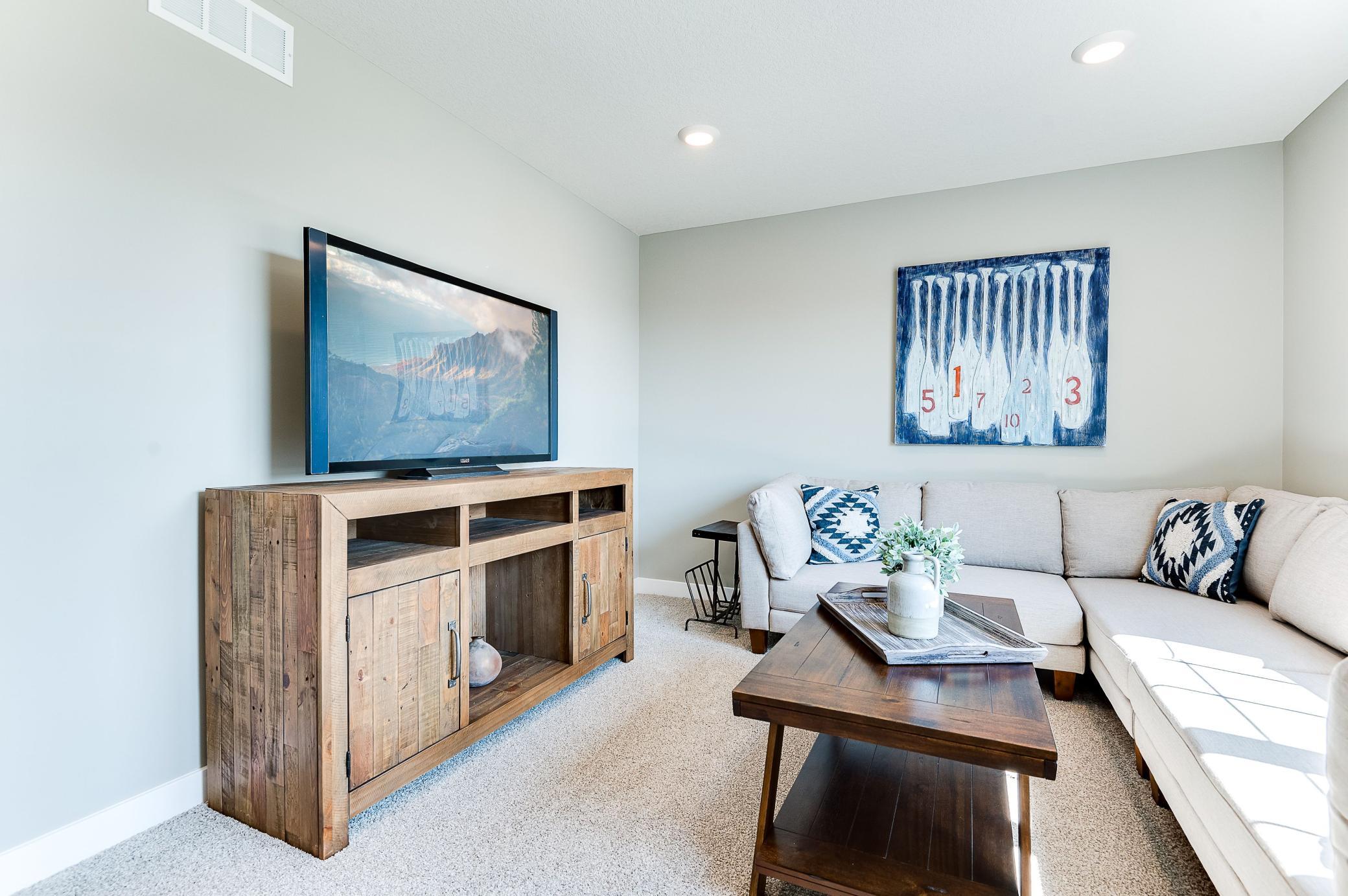 A great space to gather for family game or movie night! Photo of model home, color and options will vary.
