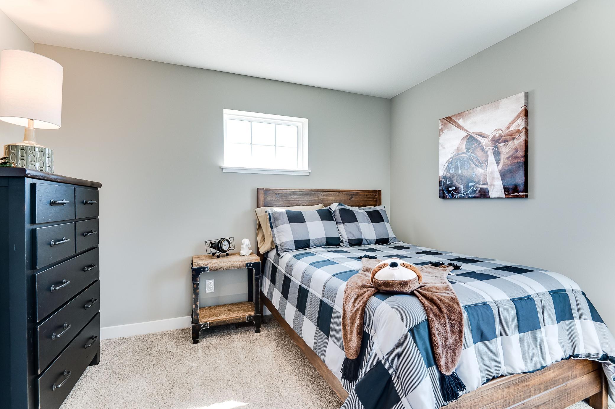 The home's upper level also features a pair of secondary bedrooms, each located just steps from an adjacent full bathroom! Photo of model home, color and options will vary.