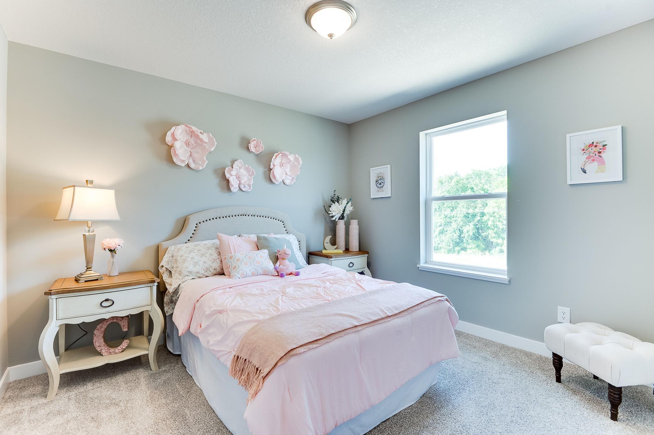 The home's upper level also features a pair of secondary bedrooms, each located just steps from an adjacent full bathroom! Photo of model home, color and options will vary.