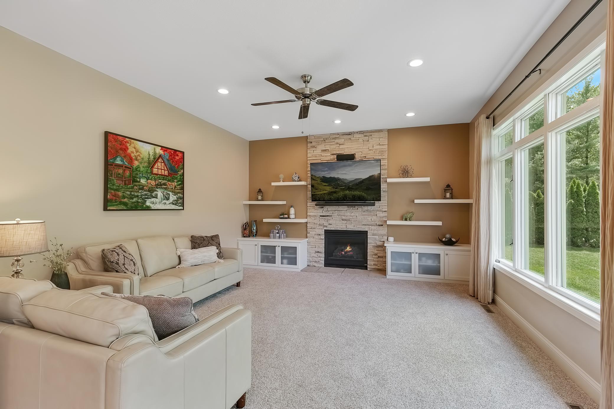 Wonderful main floor family room with gas fireplace and built in cabinets and floating shelving