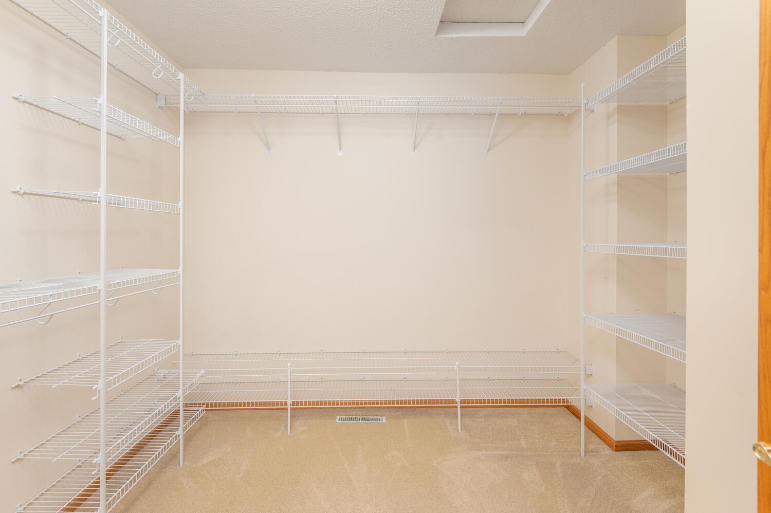 The 10 x 9 walk in closet is great! You will love the nicely designed shelving for hanging space, your folded items and shoes.