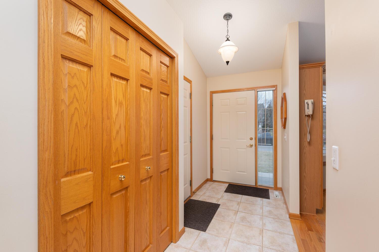 The ceramic tile entryway has plenty of room to greet guests. There is a full size coat closet and a door steps out to the garage.