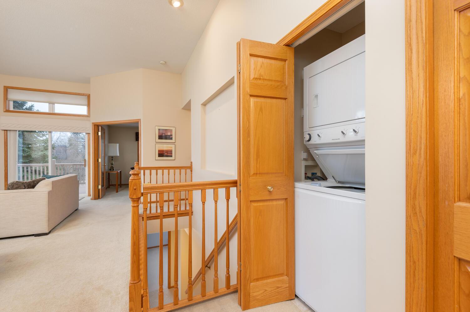 Handy main floor laundry closet with a stacked washer and dryer. Plus a lower level laundry room with full size units.