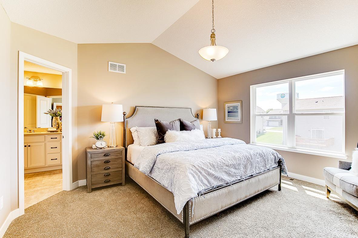 An oasis on it's own, the home's primary suite is awesome and loaded - including immediate access to one of two walk-in closets as well as a private bath that is equally appointed with features. Photo of model home, color and options will vary.
