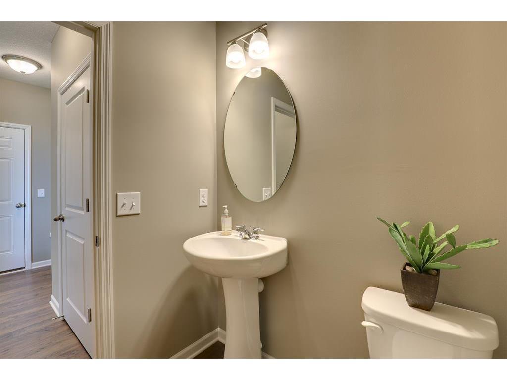 Tucked away, a powder bath on the main level is perfect for guests. Photo of model home, color and options will vary.