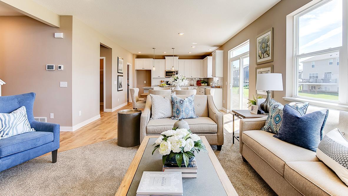The open-concept floor plan epitomizes itself in a plan that flows seamlessly from kitchen to dining to the family room! Photo of model home, color and options will vary.