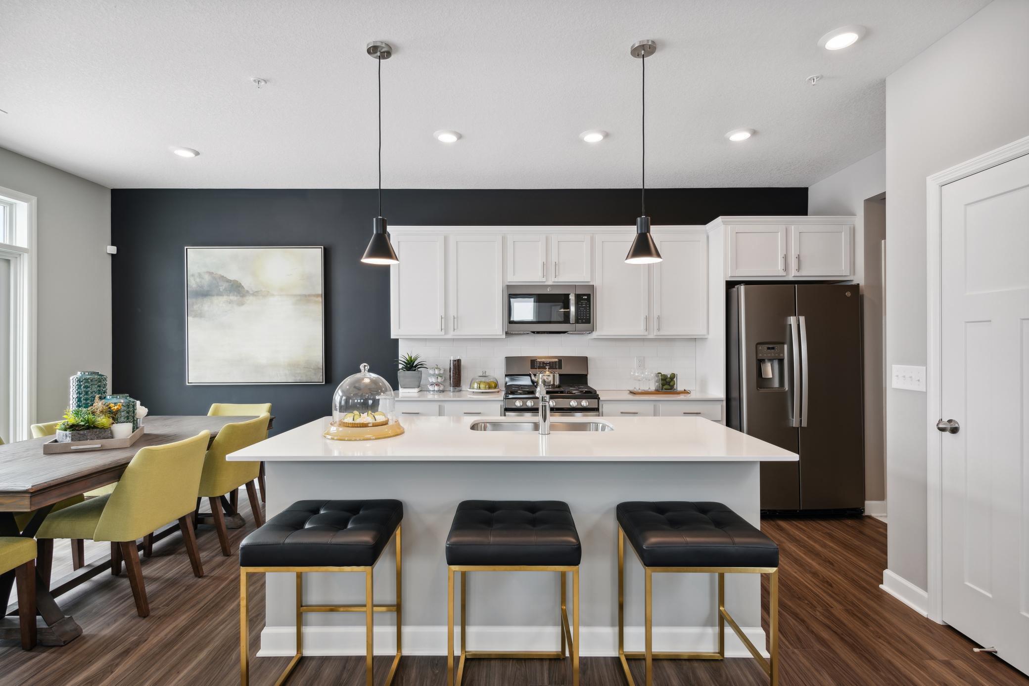 Welcome to the Raleigh at Weston Commons! A Spacious kitchen and dinette with convenient sliding glass door. *Photos of model home; colors and finishes will vary.