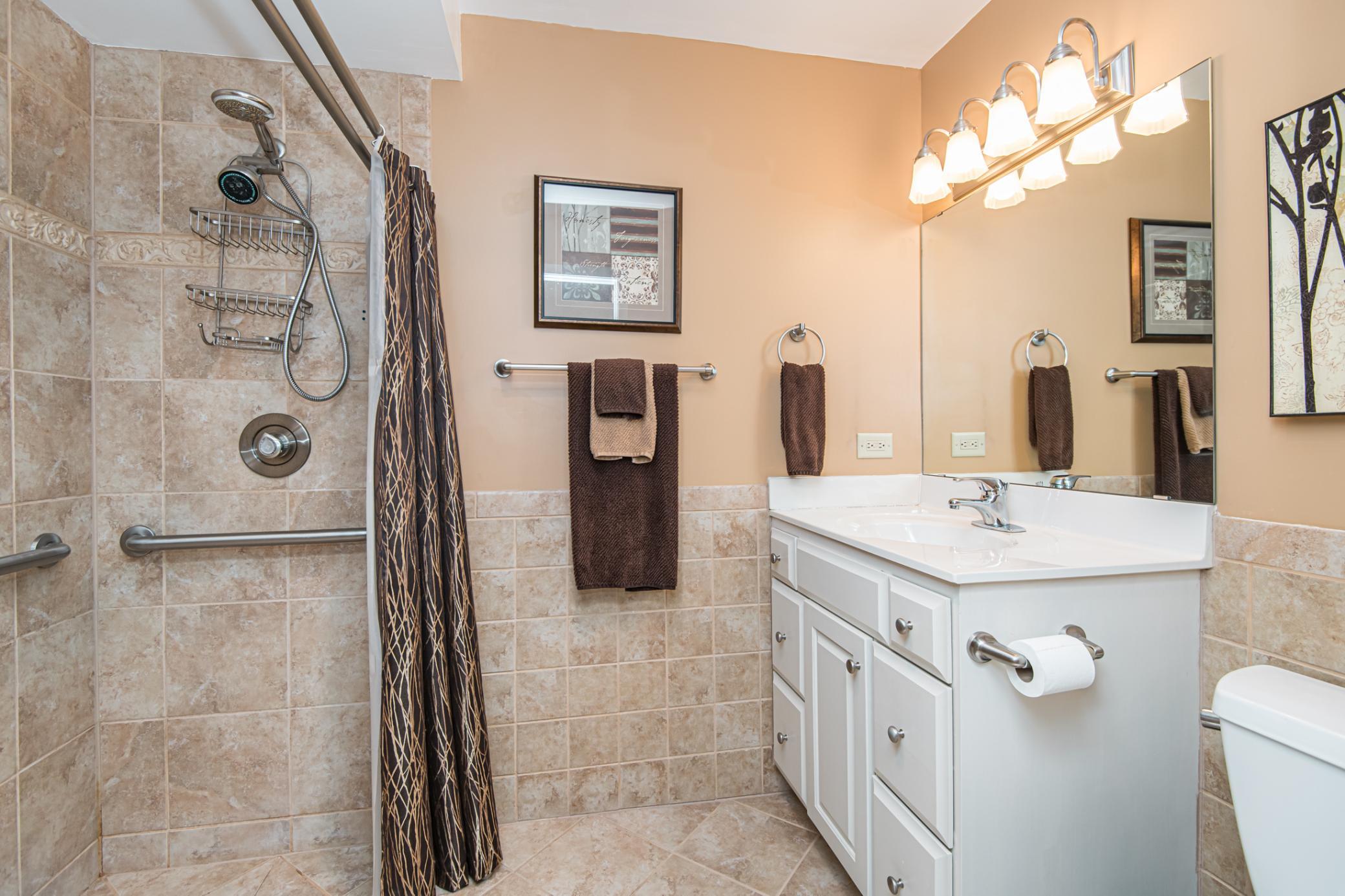 Master bath with nice-sized vanity and step-in ceramic shower (handicap accessible)!