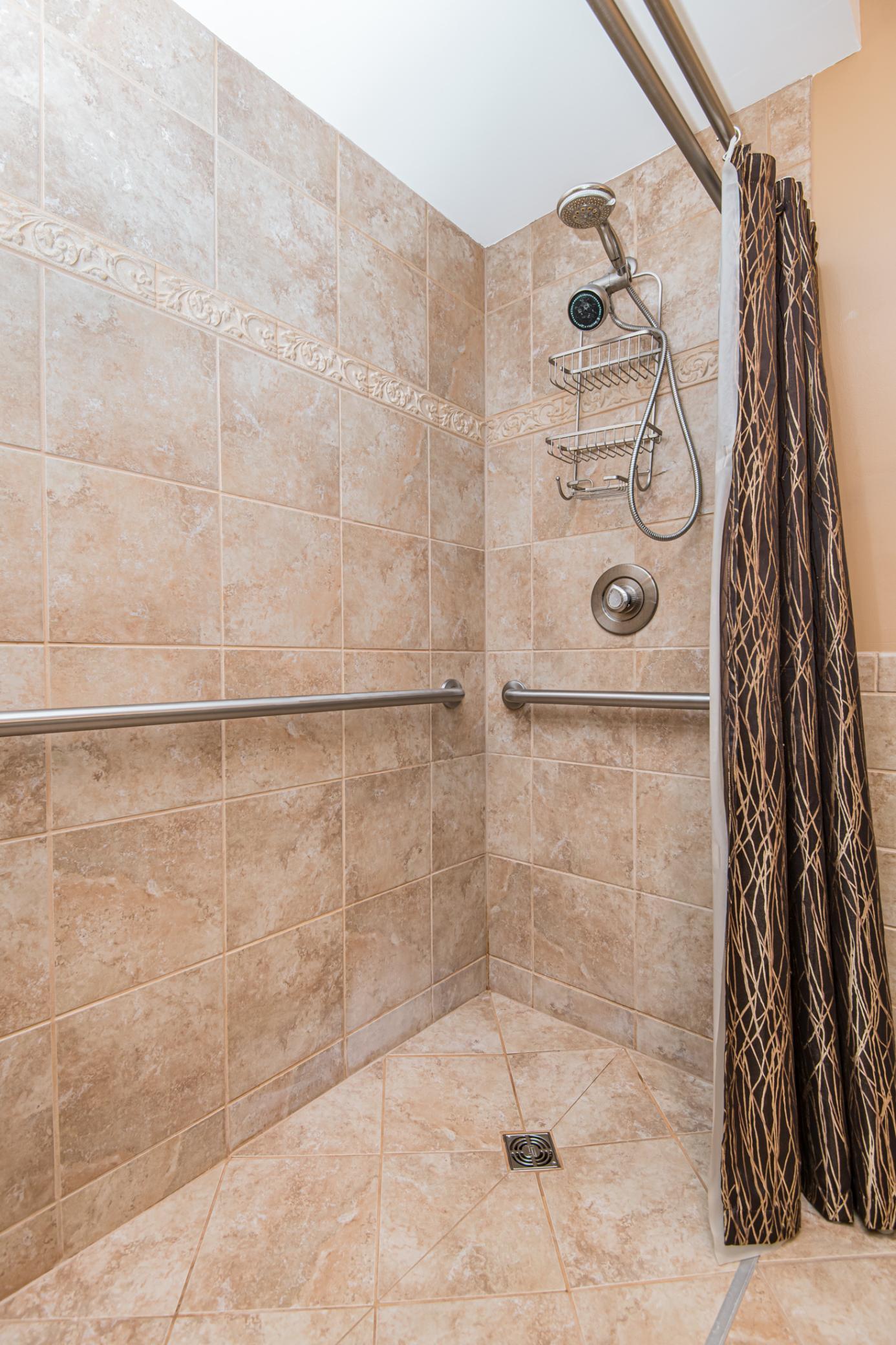 Master roll-in shower with handicap bars.
