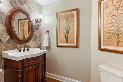 A stylish 1/2 bath, with full tile wall, is located on the main floor near the family room.