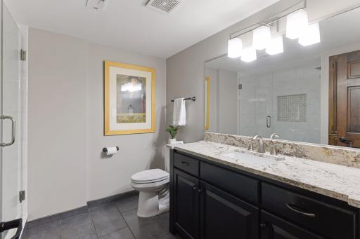 Bathroom #4 has beautiful granite and tile.
