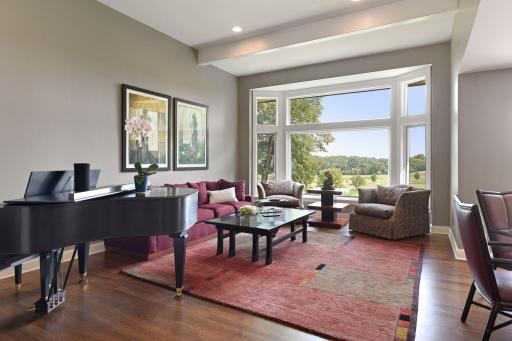 Your guests will be drawn in to this gracious living room by the large windows and extra high ceiling.