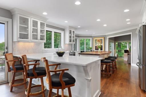 Kitchen features stylish and bright quartz countertops and backsplash.