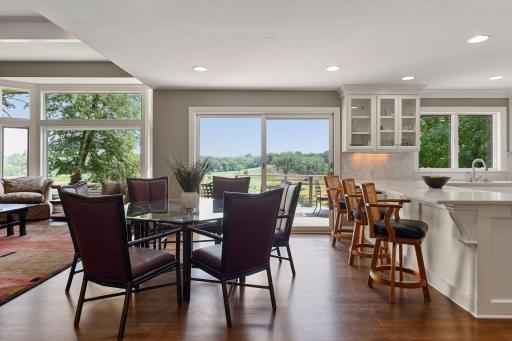 Additional dining space between living room and kitchen is perfect when entertaining larger groups. Sliding doors lead out to the main level deck.