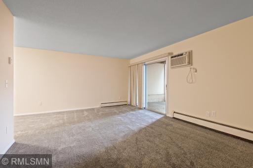 Generous size living room with new carpet and fresh paint. sliding glass doors lead to private patio.
