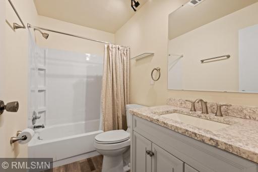 Newly updated bath includes new flooring, vanity, toilet, sink and fixtures.
