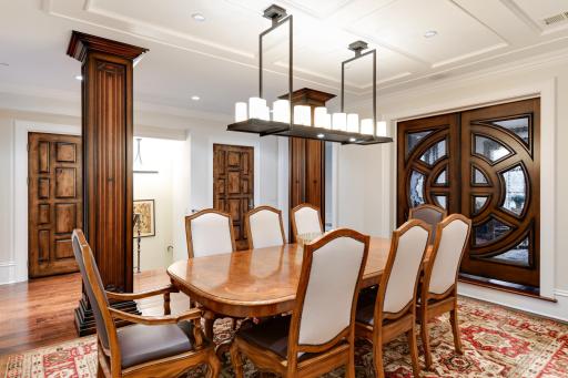 The millwork and doors are all custom and offer beautiful detailing, coffered ceiling, pillars, open staircase