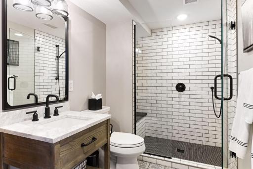 Beautiful and modern remodeled lower-level ensuite bathroom with heated floors.