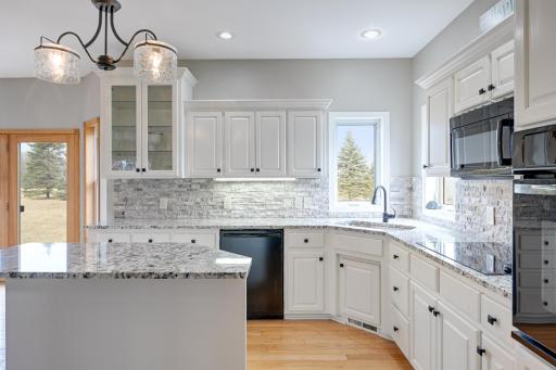Chef's workspace is outlined with granite tops & stone backsplash