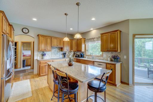 Kitchen is equipped with ample storage space, newer stainless-steel appliances, granite countertops, and a center island