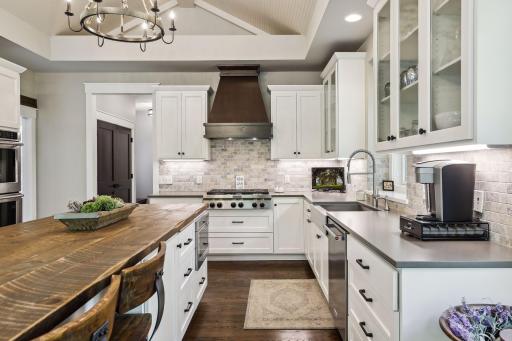 Beautiful custom enameled cabinets and Cambria countertops adorn the kitchen
