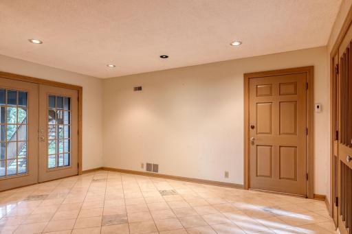 FOYER with access to the Double Attached Garage on the right and a sliding glass door to a Patio in the backyard.