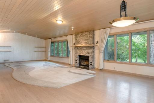 Spacious and gracious vaulted Living Room with stone Fireplace.