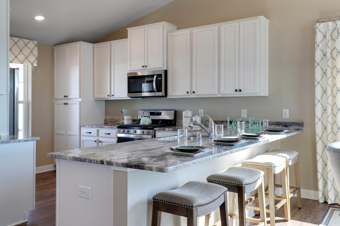 The popular Rushmore boasts a kitchen that is equal parts smart and useful - and comes loaded with a stainless steel appliance package. Photo of model home, finishes will vary.