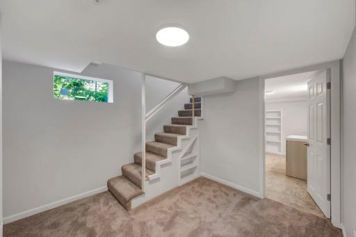 The basement stairs open to an area that would be perfect for a home office, craft, or exercise area.