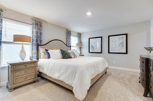 The primary bedroom is the perfect setting to start and finish each day! Furnished with a King size bed and furniture with plenty of space leftover. Photo of model, colors and options will vary.