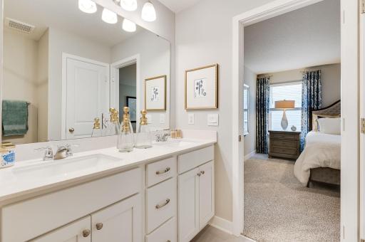 In addition to the space provided in the primary bedroom, the attached bath provides a true oasis to come home to, featuring a double vanity and stand-in shower. Photo of model, colors and options will vary.
