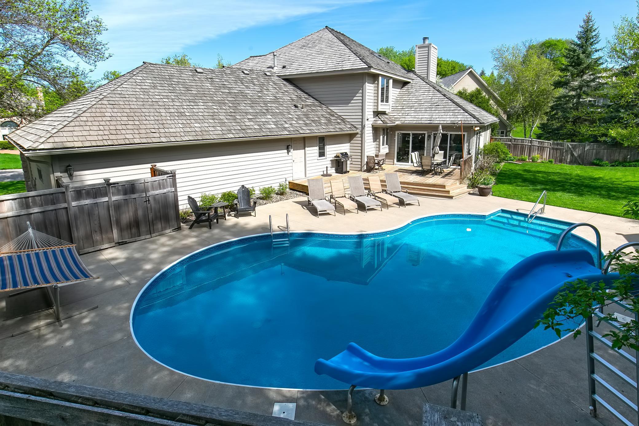 Remarkable Home!!! Check out this outdoor entertaining space with heated swimming pool, deck/patio and 3 season porch - just in time for summer!