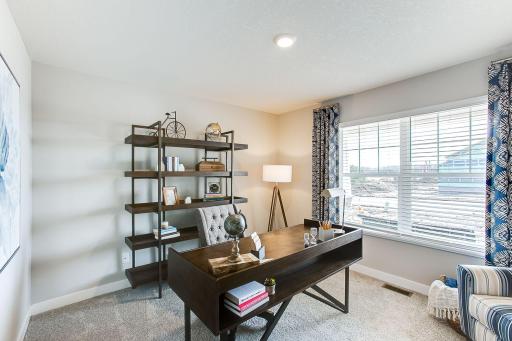 In addition to the vast living spaces on the main level, the home also includes this flex space, accessed by French doors - which can serve as a home office, toy room, formal dining area and more. Photo of model, colors and options will vary.
