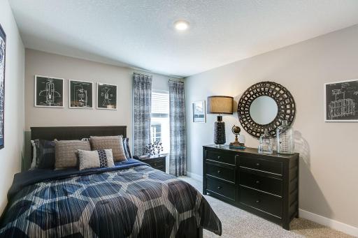 In addition to the primary bedroom, the home's upper level also includes these two additional bedrooms, and another full bathroom just adjacent to each! Photo of model, colors and options will vary.