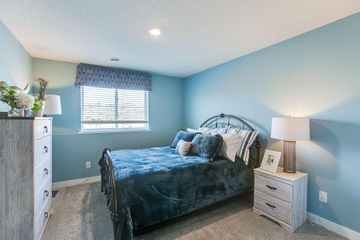 A forth bedroom resides on the lower-level, located across from a full bath. Photo of model, colors and options will vary.