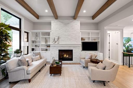 The floor plan features a spacious Family Room with high ceilings and an inviting gas fireplace flanked by custom built-ins. Photos of similar model.