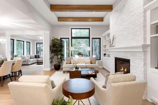 Large windows and high ceilings fill the home with natural light. Photos of similar model.