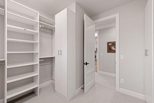 The master suite is complete with a large walk-in closet. Photos of a similar model.