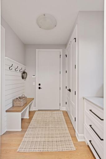 A light and bright Mudroom is the perfect space for entering the home with ample built-ins. Photos of similar model.