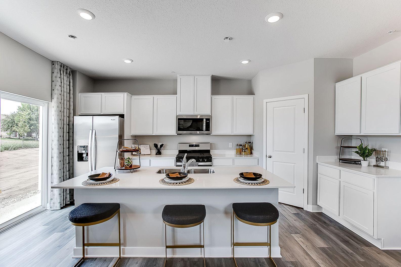 Town home living just got an upgrade with the large island, spacious walk-in pantry and tons of cabinets.