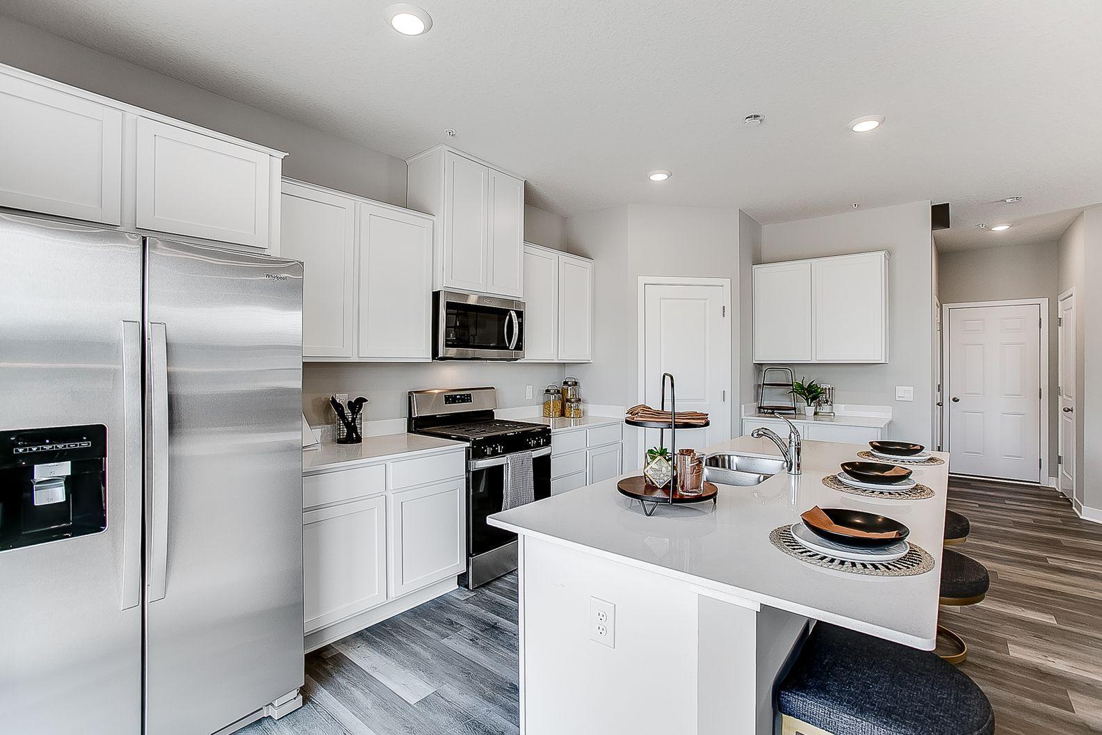 Stainless steel appliances featuring a gas range and microwave that vents to the exterior.