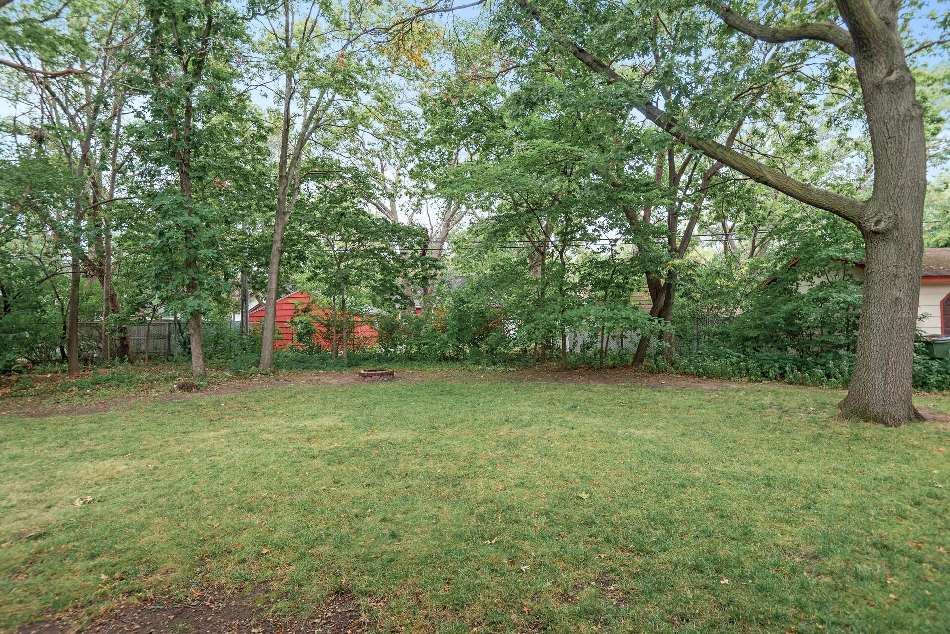 Mature trees and bushes outline and nice sized yard for endless opportunities