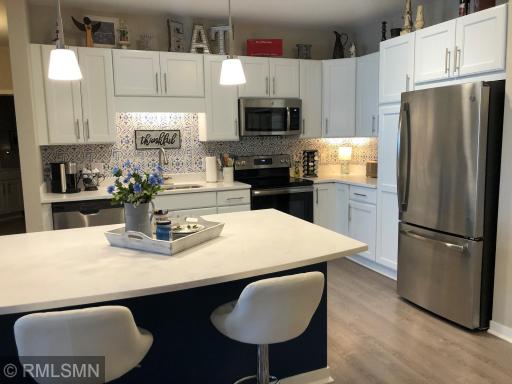 Cooking is a pleasure in this beautiful yet functional kitchen with plentiful cabinetry, stainless steel appliances and a convenient center island/eating bar.
