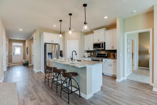 A kitchen built to perform! Equipped with stainless steel appliances, granite countertops and a large island, this kitchen adds distinction and character! *Photo of previous model home