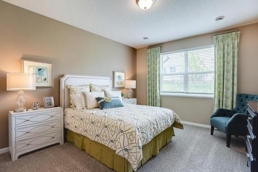 Enjoy starting your day in the comfort of your beautiful primary suite. Located just off the dining room, this primary suite makes main level living easy. *Photo of previous model, selections will vary.